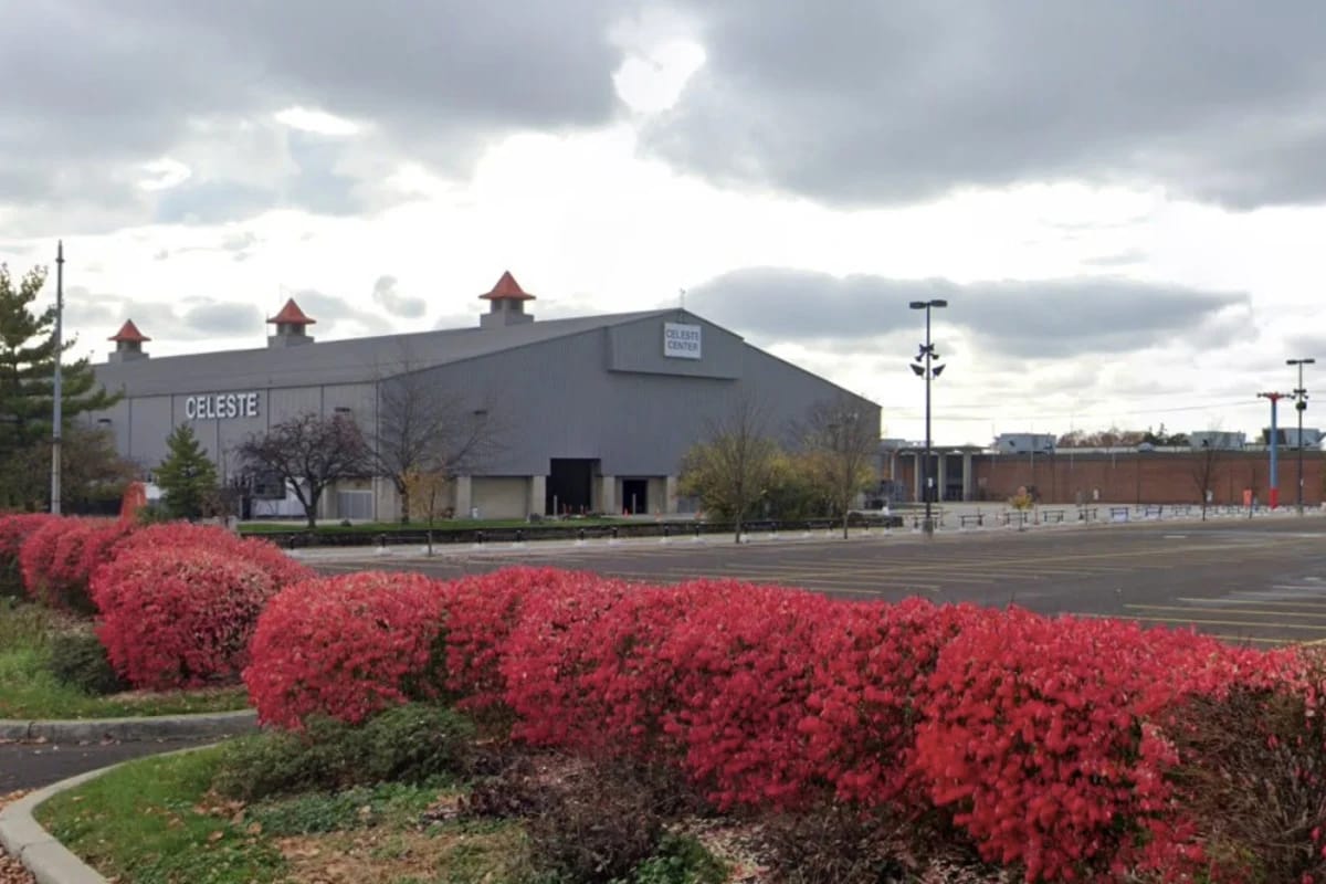 Celeste building, venue for Columbus India Fest, with vibrant red bushes in foreground.