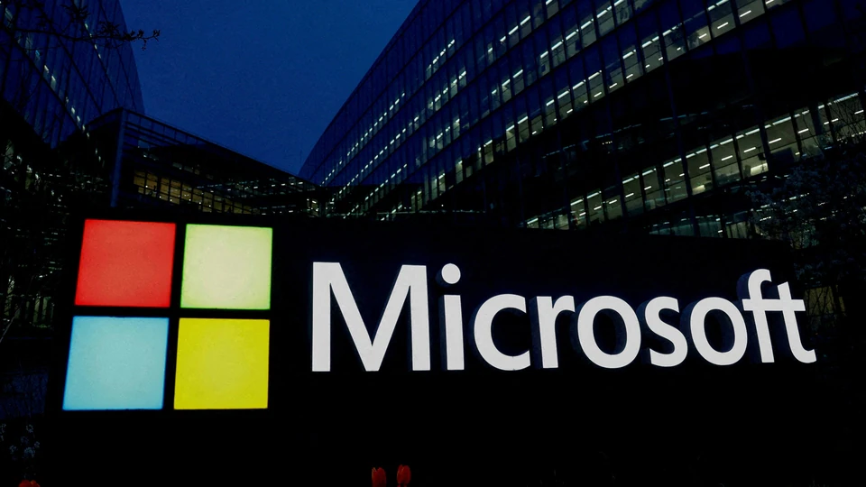 Microsoft logo and building at dusk, highlighting the tech company's presence.