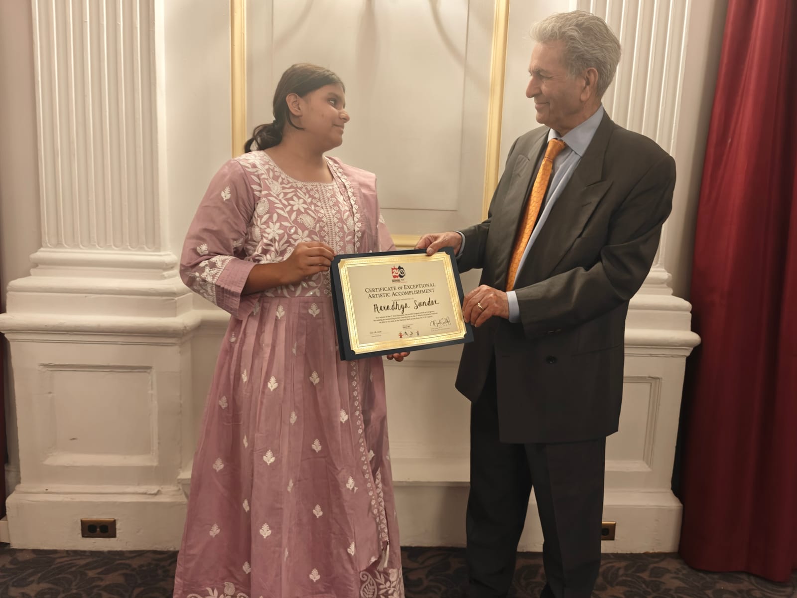 Young girl receives award at DC Arts Olympiad, a sports competition.