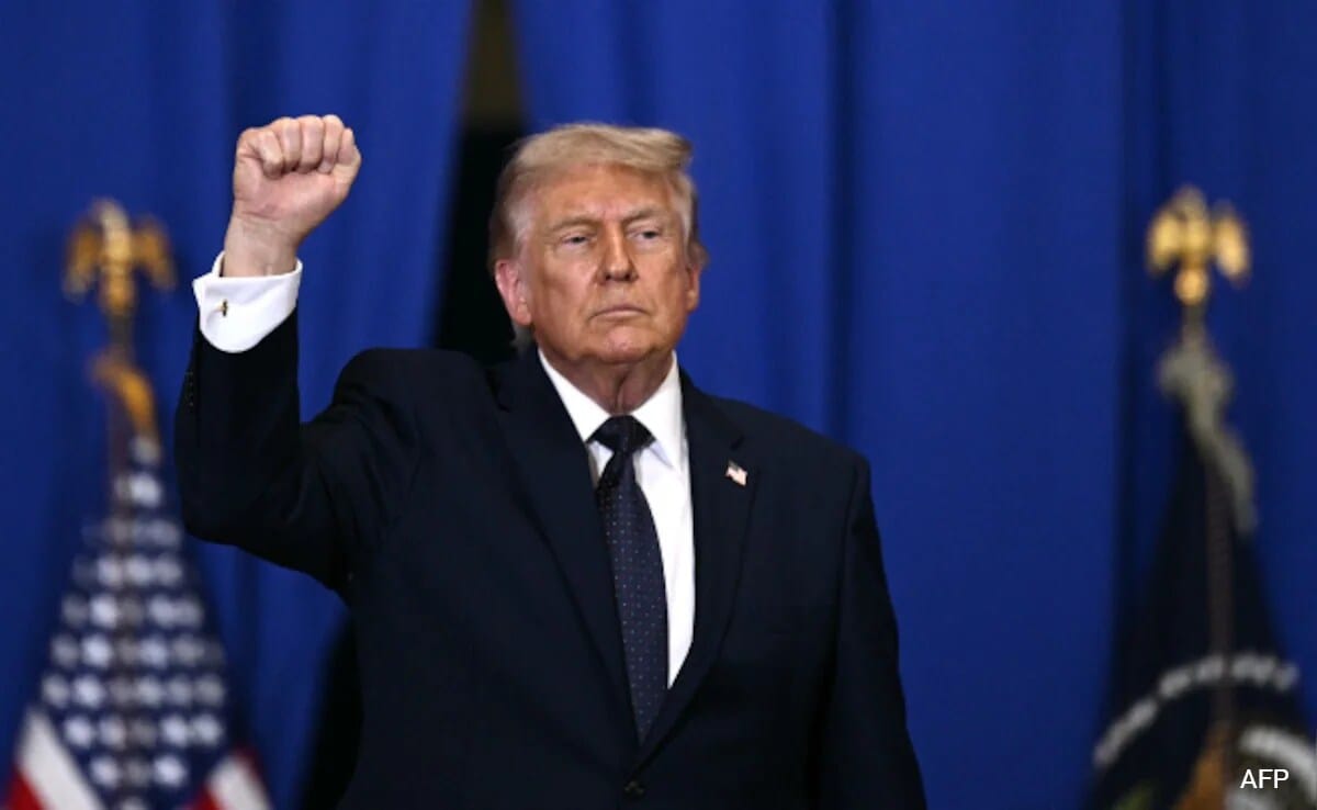 Donald Trump raises fist, relevant to new Democratic bill targeting his green card policy.