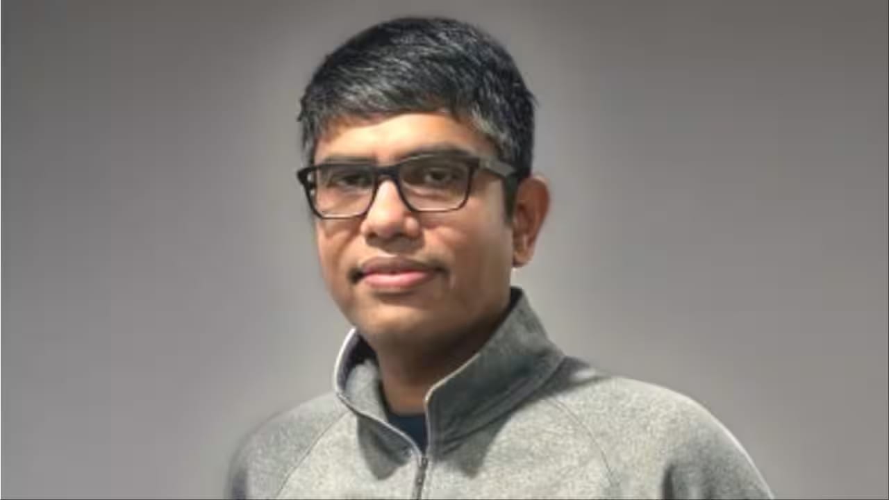Adobe executive, a man wearing glasses and a grey jacket, in news.