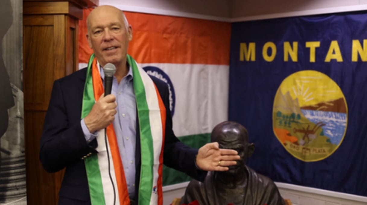 Montana Governor Greg Gianforte with Indian flag and Gandhi statue.