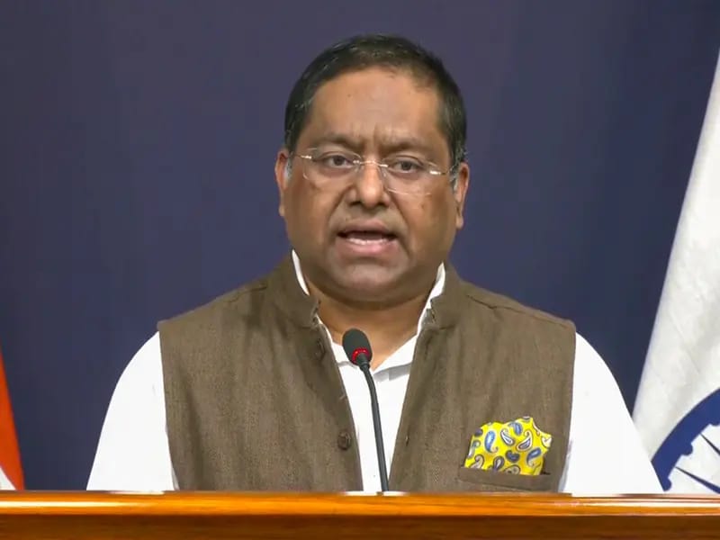 Indian politician speaks at podium, relevant to US $100K grad work fee