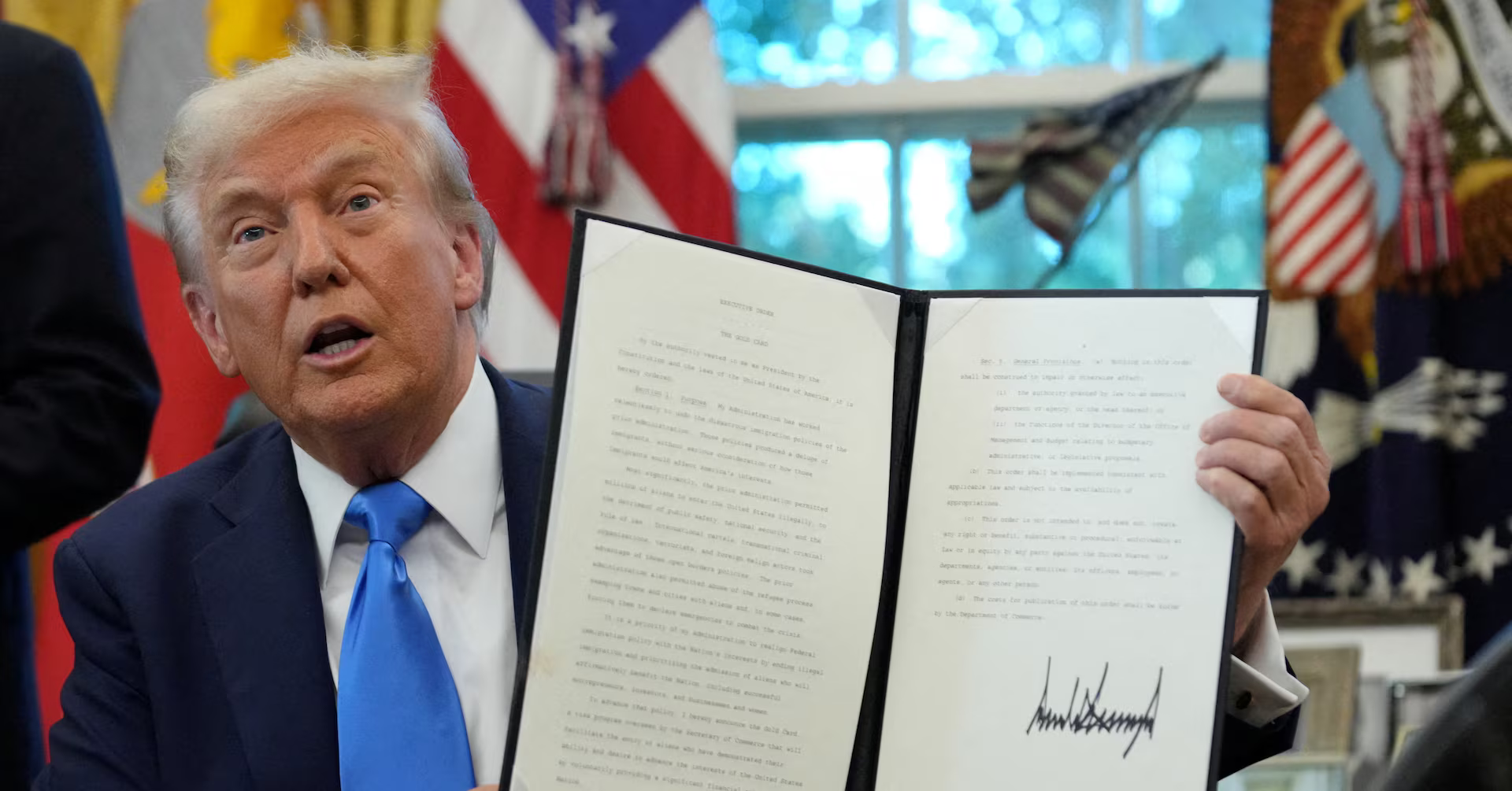 Donald Trump holds H-1B visa document, center of fraud investigation.