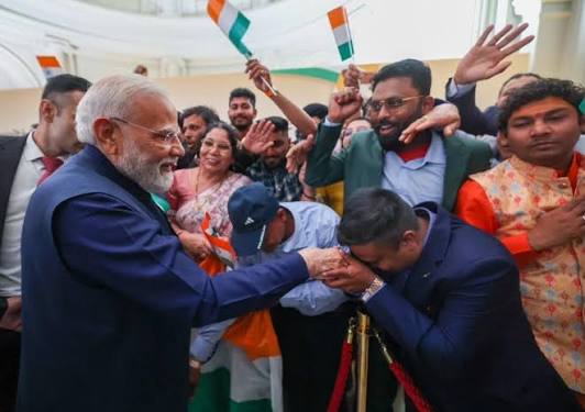 Narendra Modi greets Indian diaspora in NZ, flags in background, politics