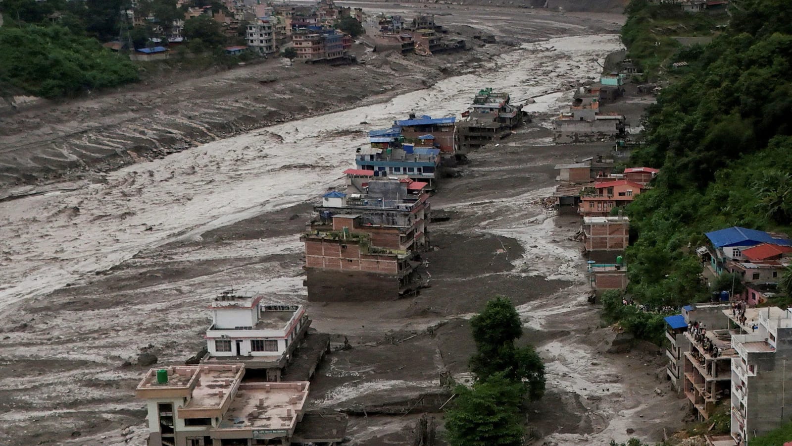 Nepal flood aftermath: Muddy river inundates buildings, news of US aid.