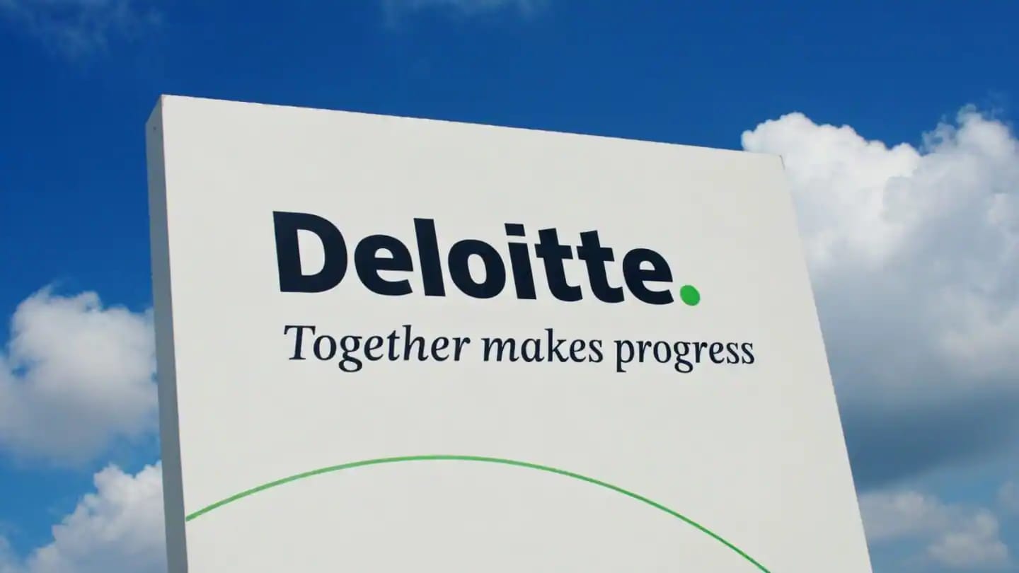 Deloitte logo and slogan "Together makes progress" on a white sign outdoors.