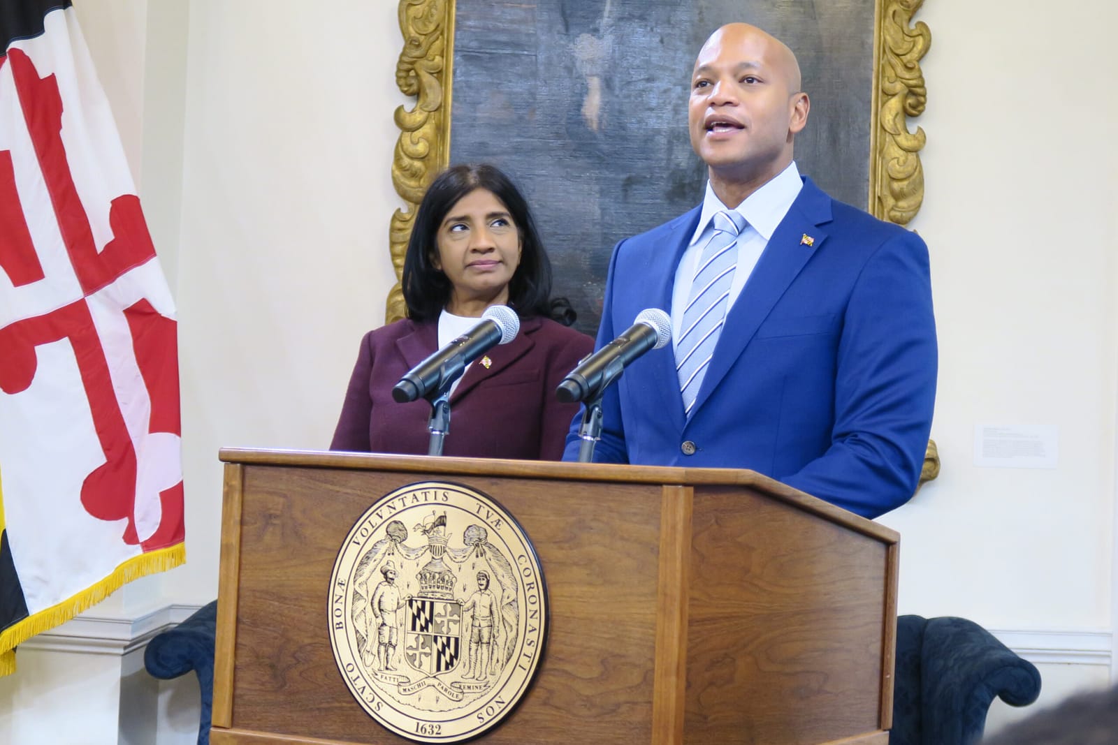 Maryland leaders Wes Moore and Aruna Miller at a podium, discussing tech.