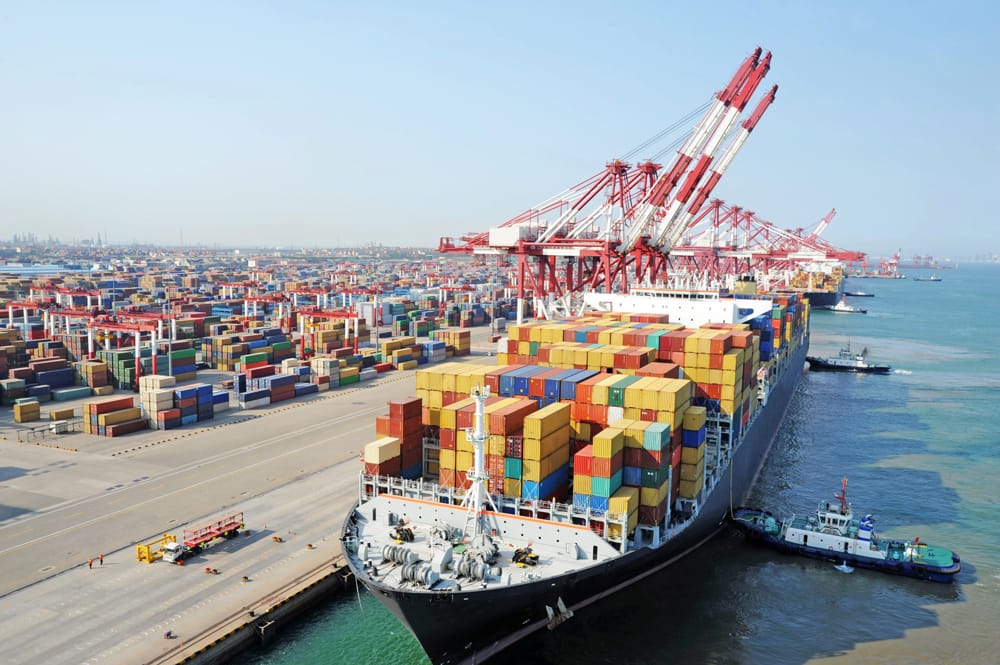Large container ship at busy port, symbolizing global business and trade.