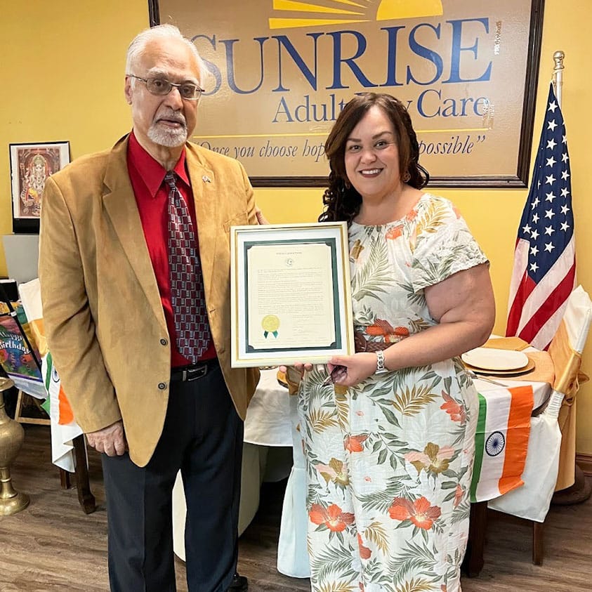 Greenacres, FL news: Man and woman hold proclamation for India's Independence Day at Sunrise Adult Care