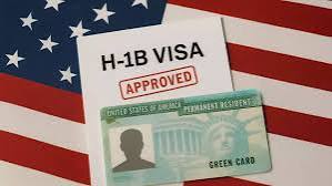 H-1B visa approved stamp and Green Card on US flag
