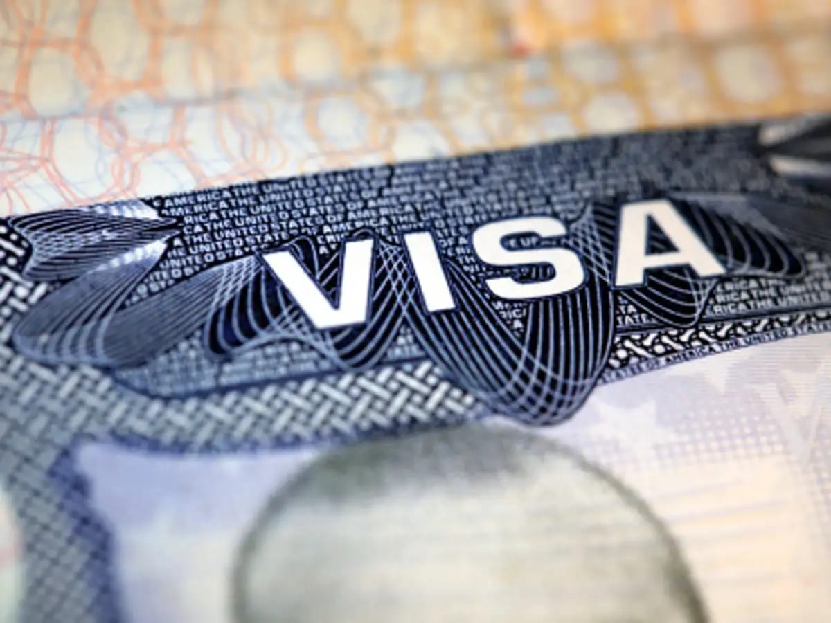 Close-up of a U.S. visa stamp with the word "VISA" prominently displayed.