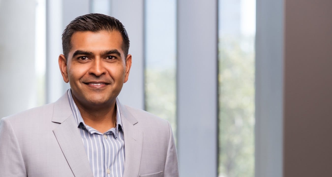 Dhruv Patel, Indian American President and COO at McCarthy, smiles for a professional headshot.
