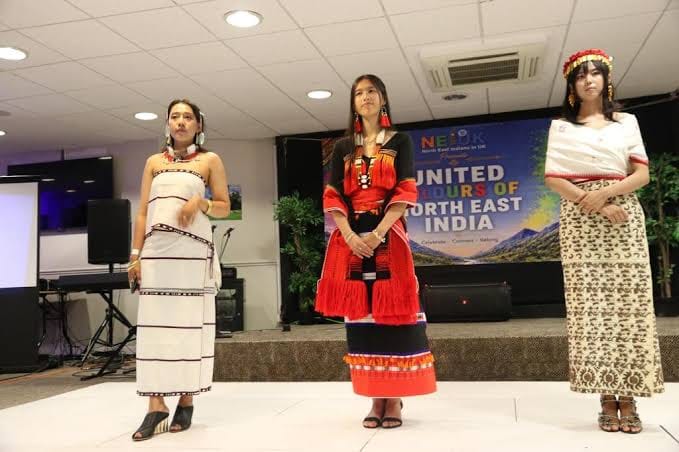 Northeast Indian cultural display at London festival with women in traditional attire.