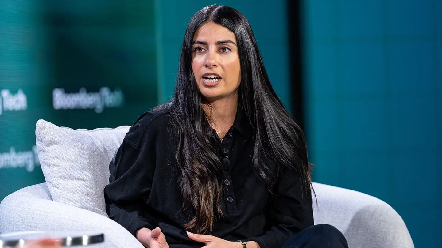 Woman speaking at a Bloomberg Tech event, relevant to US company visa and immigration issues.