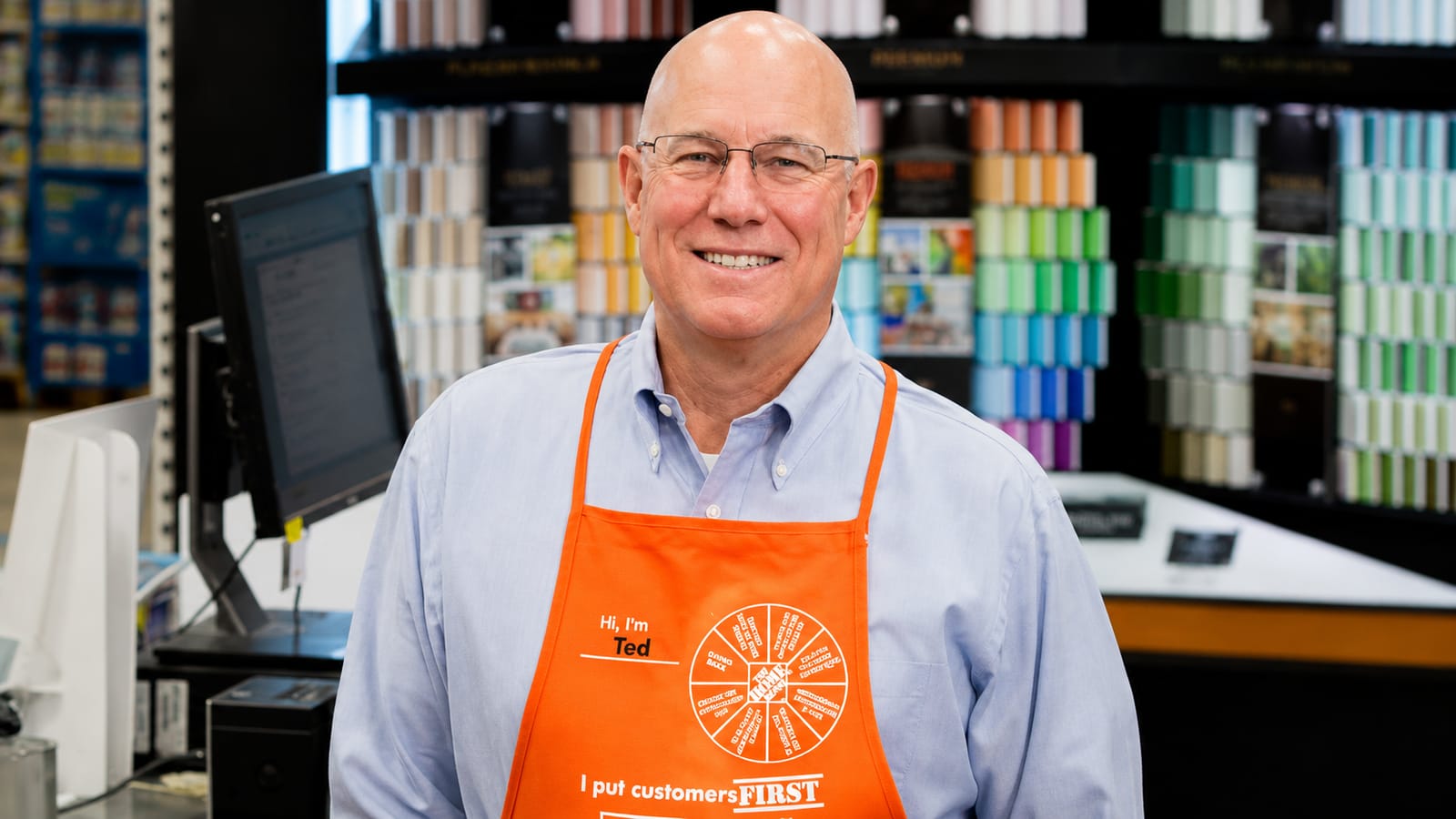 Home Depot employee Ted wearing an orange apron, smiling at the camera.