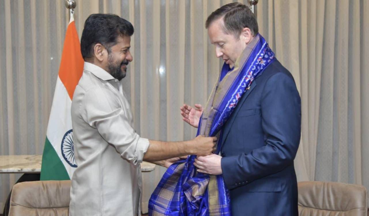 Revanth Reddy presents a shawl to US envoy, discussing H-1B visas.