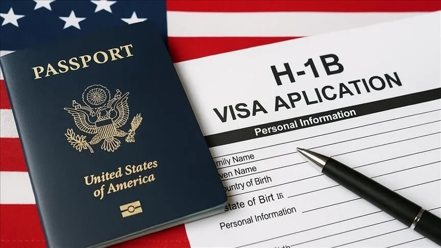 US H-1B visa application form with passport and pen