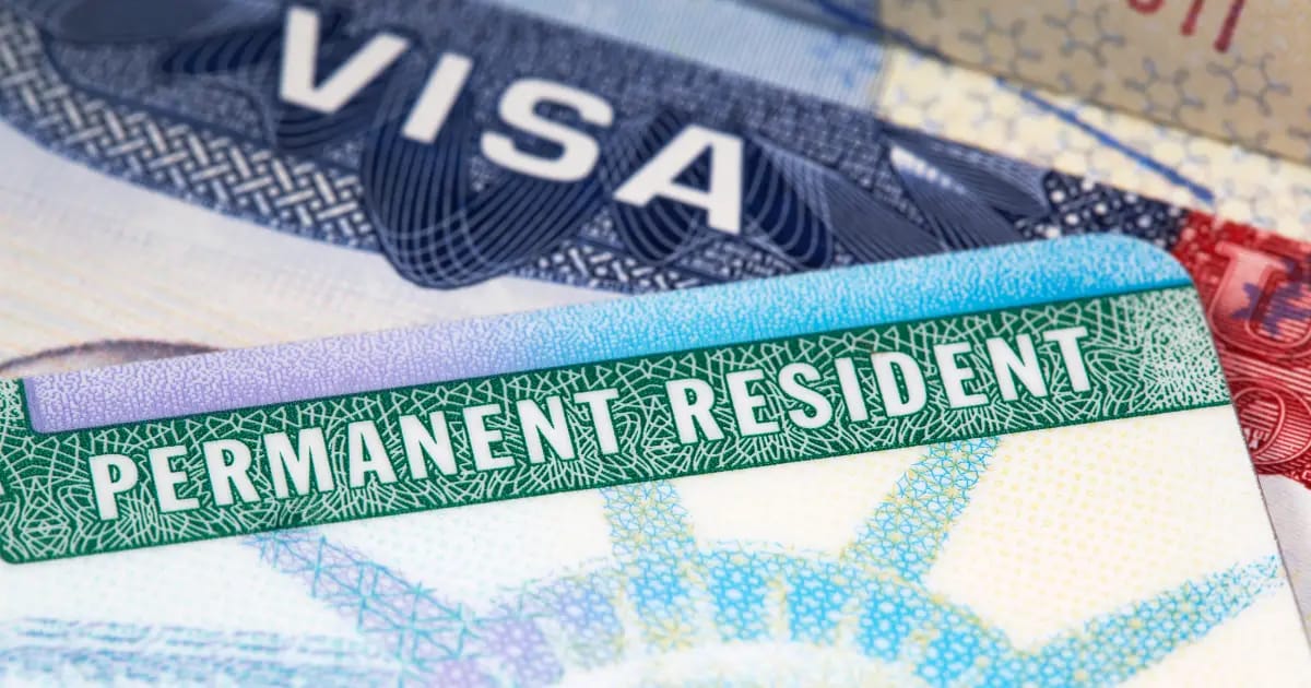 Close-up of a US Permanent Resident card and a visa, related to immigration.