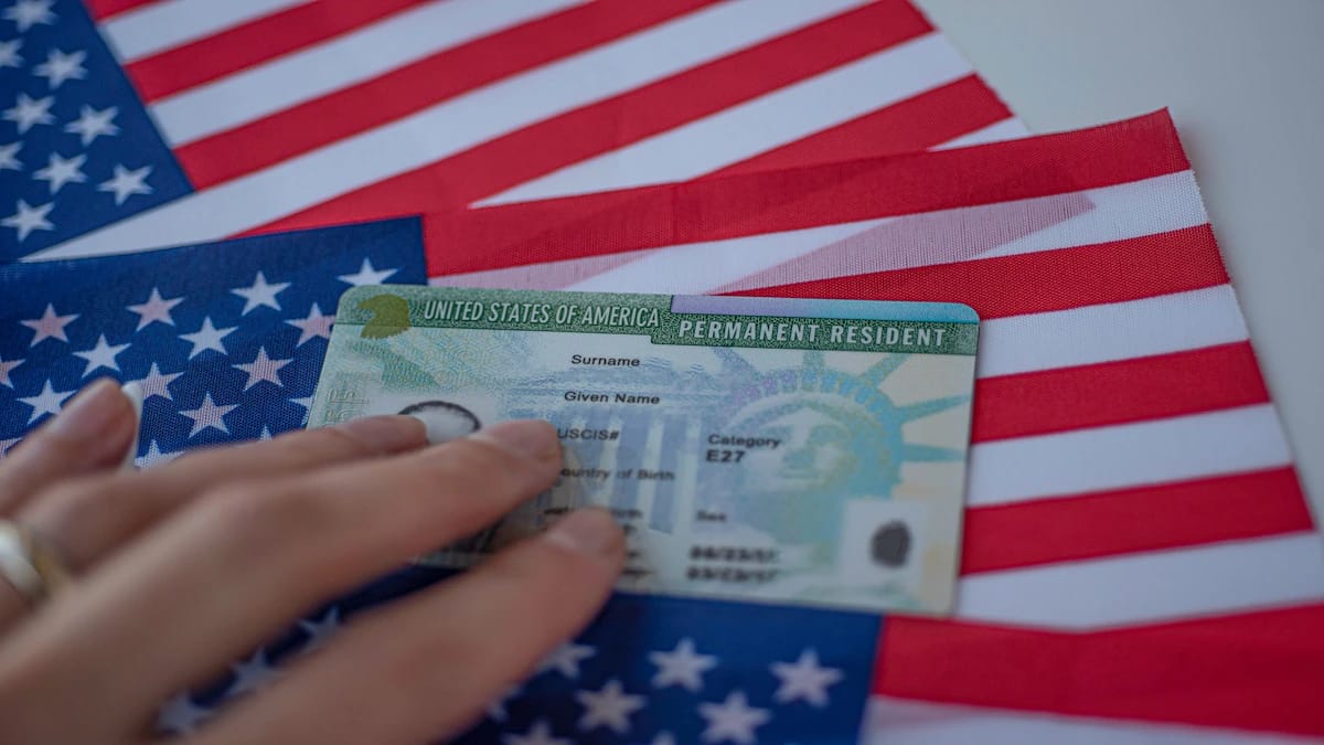 US Green Card with Statue of Liberty, on American flags, relevant to US immigration