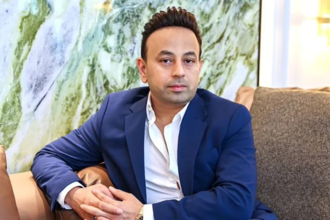 Satish Sanpal in a blue suit, business professional