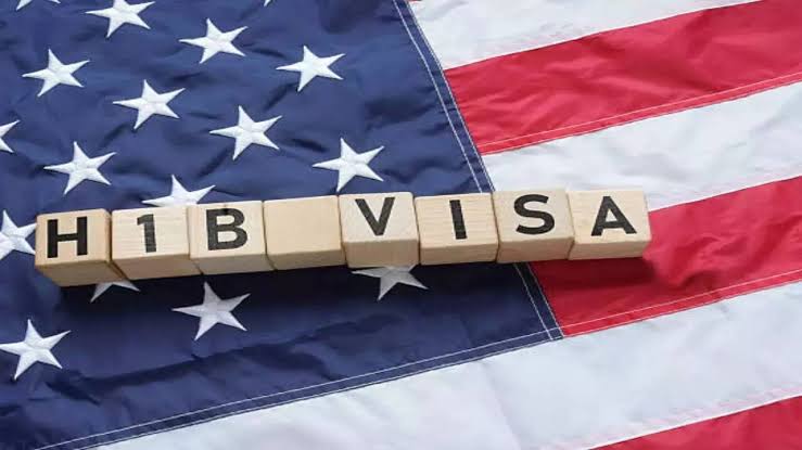 H-1B Visa blocks on an American flag, representing visa and immigration issues.