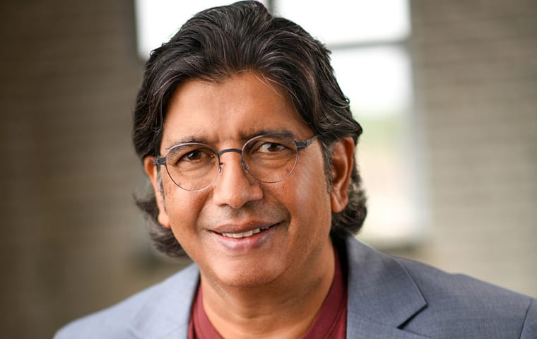 Ravi Bapna, Indian American AI expert, smiles in a suit.
