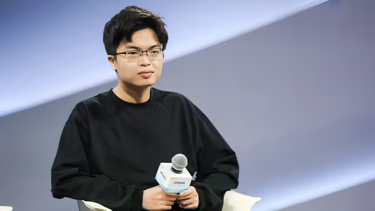 Yang Zhilin, Chinese tech CEO, speaks into a microphone at a conference.