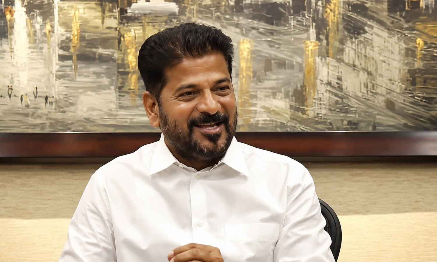 Telangana CM Revanth Reddy in white shirt, news about US trip ban