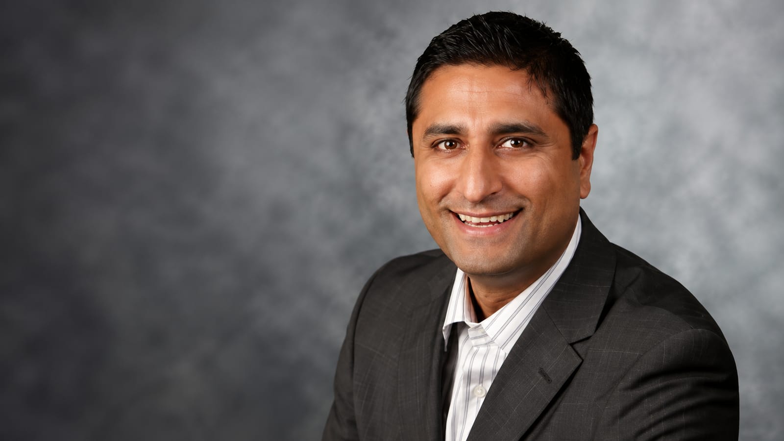 Indian American Dipan Patel, COO of Duos Technologies, smiles in a tech business portrait.